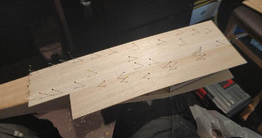 Pieces of balsa sheet with pins in
