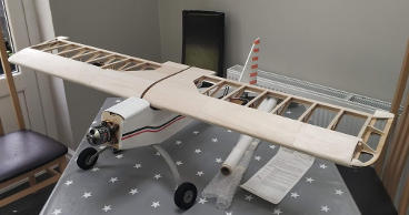 Photo of uncovered wing resting on the fuselage